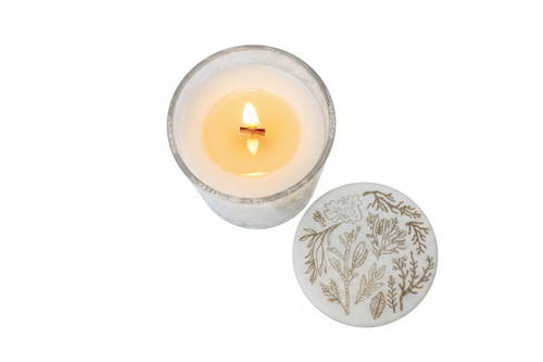 Botanical glass candle top-down view with flame
