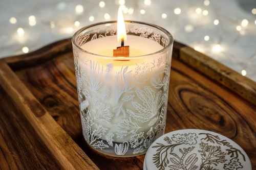 Botanical candle lifestyle shot with fairy lights on wooden tray